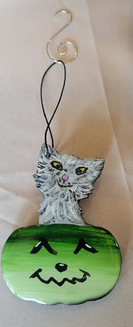 Playful Purrfection: Smirking Cat in a Jolly Green Pumpkin Ornament