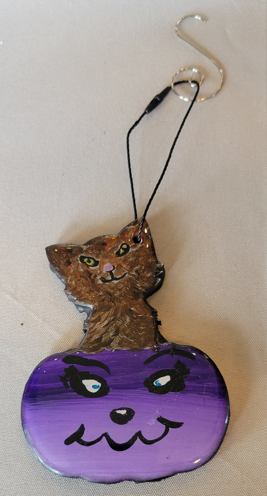 Spooky Smirks: Mischievous Cat in a Bewildered Purple Pumpkin Ornament