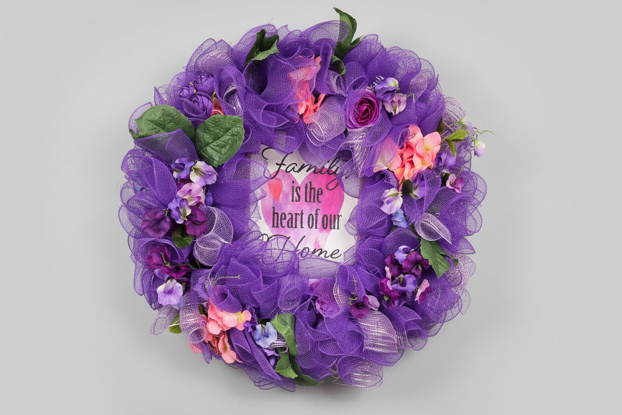 Purple decorative wreath with flowers and text on a wooden surface.
